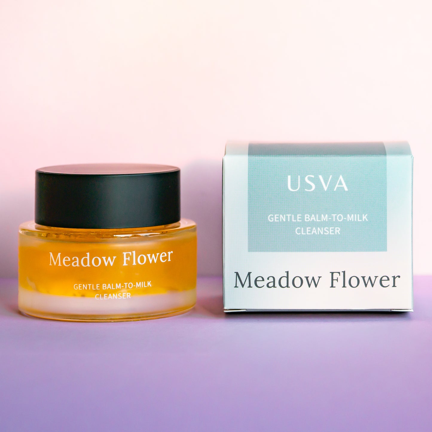Meadow Flower skincare product jar with packaging on a pink background